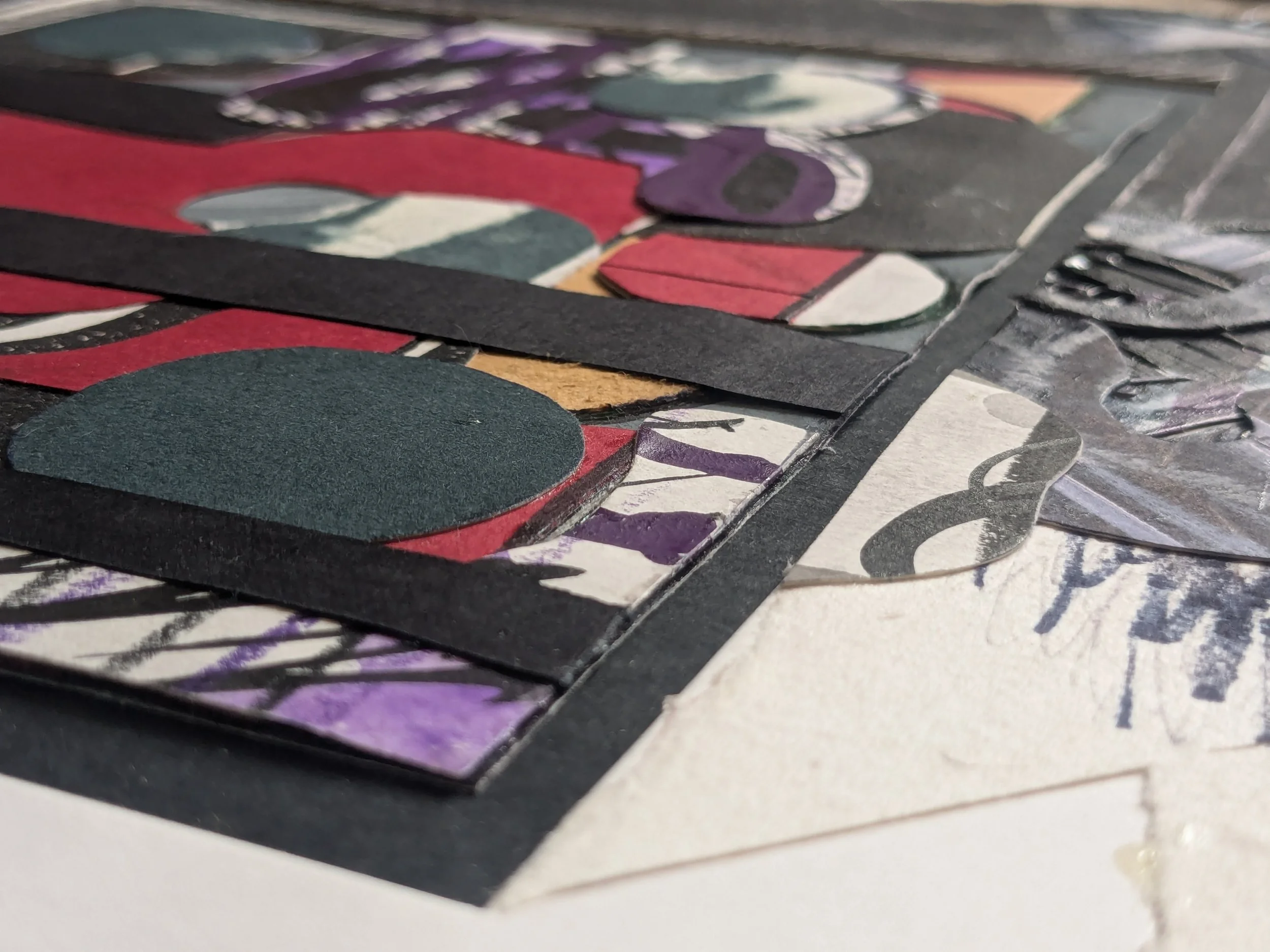 Close-up of a mixed-media collage artwork with colored paper, ink, and paint, featuring abstract shapes and layered textures.