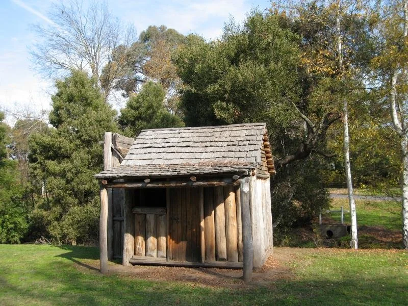 Replica miner’s hut built in 2001, shown in pristine condition shortly after construction, representing a finished interpretation of goldfields housing.