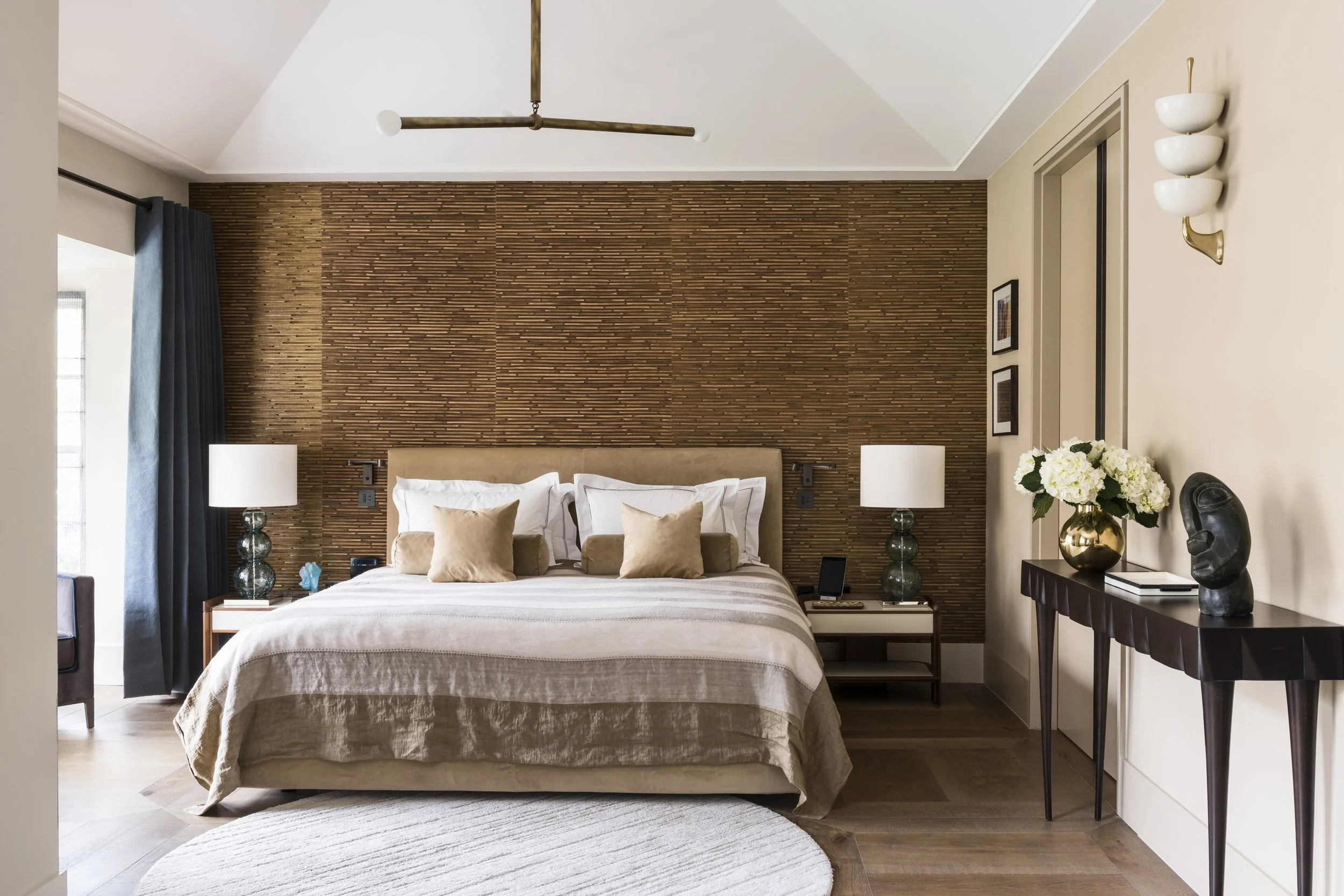 A bedroom with a doorway to an en-suite bathroom in a property redesign