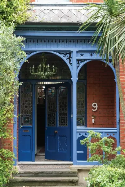 Exterior updates:  ornate blue front door and porch