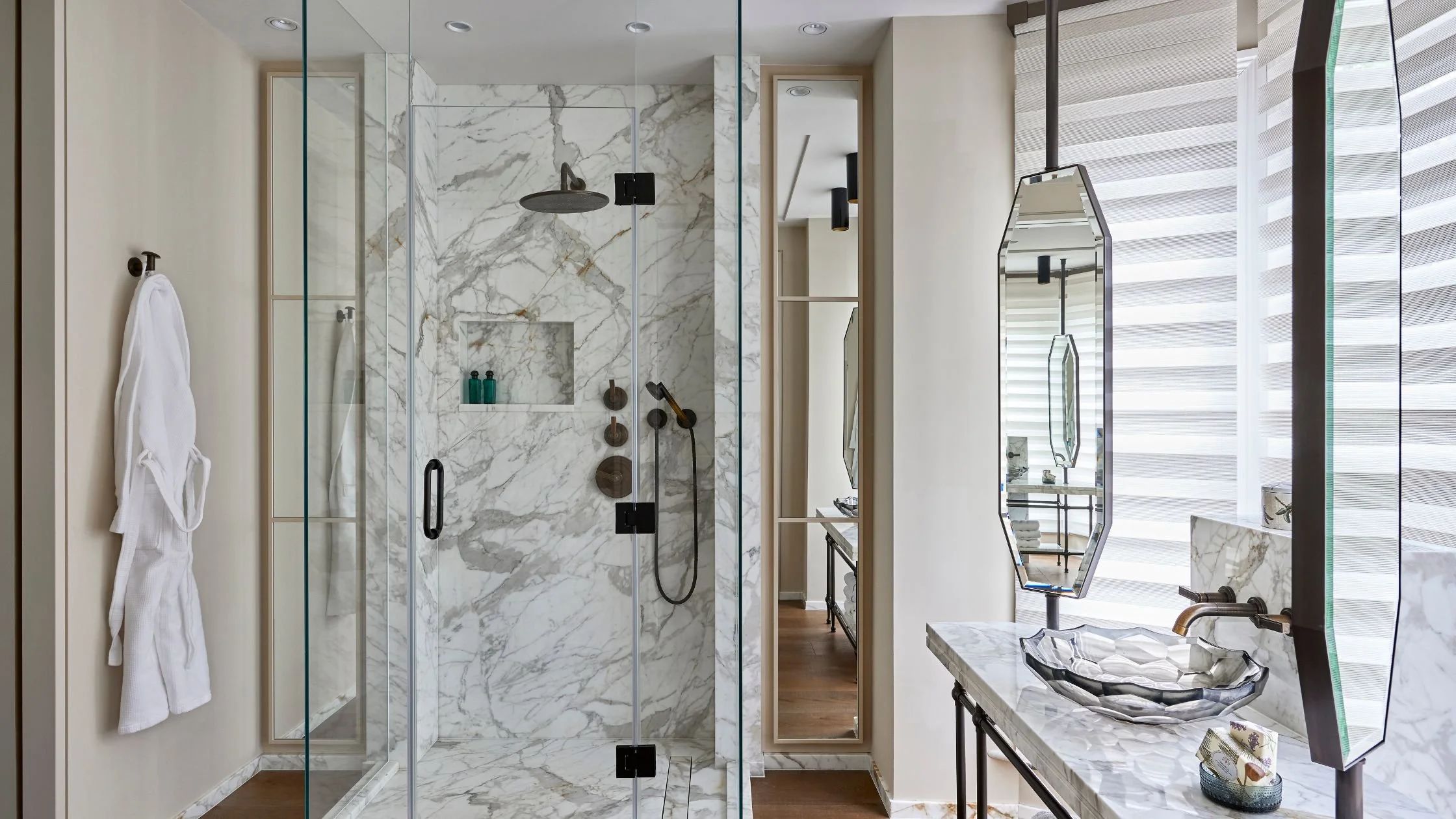 A bathroom with mirrors and marble shower area in house redesign.jpg