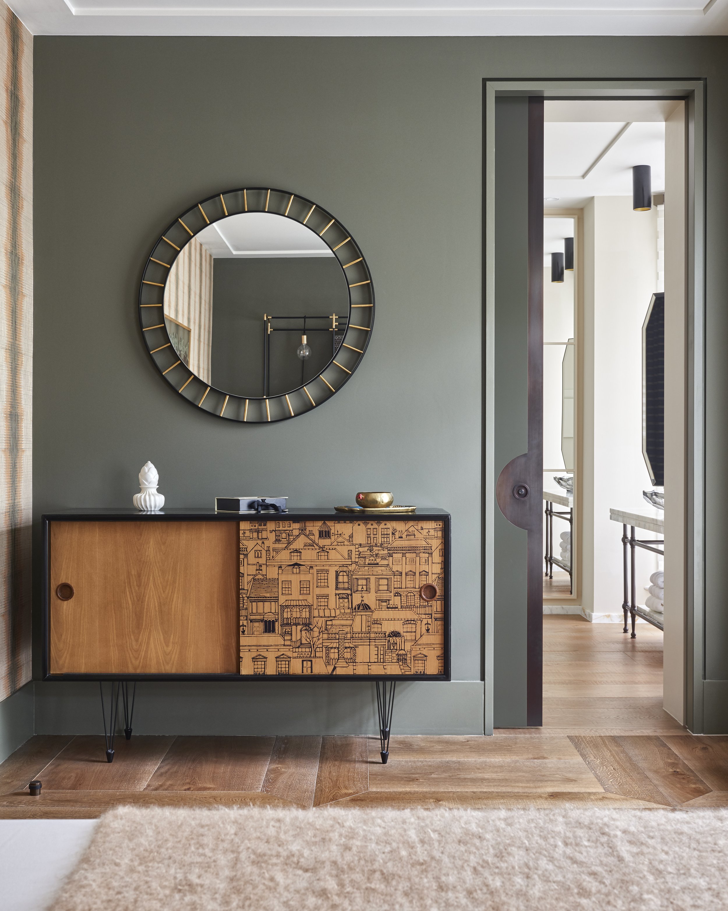 A green dining room in a renovated house