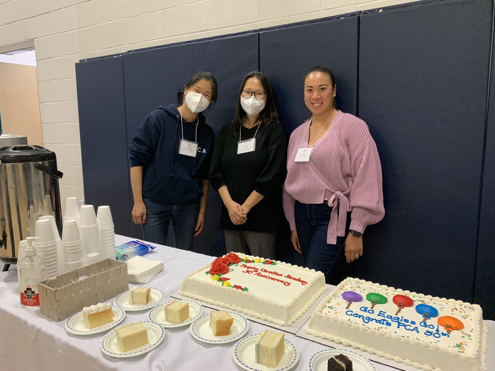 Parent volunteers serving food at an event
