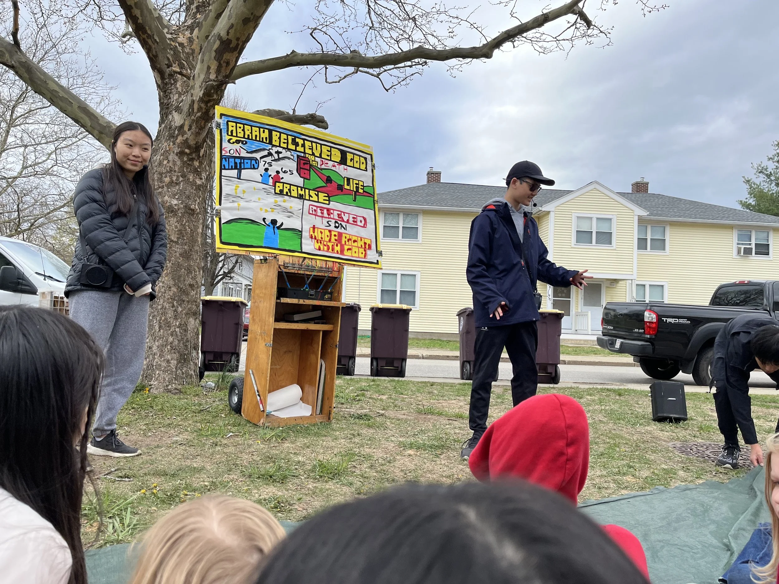Day 4 - Mission team members sharing the story of The Call of Abram with  neighbourhood children at Kids Camp