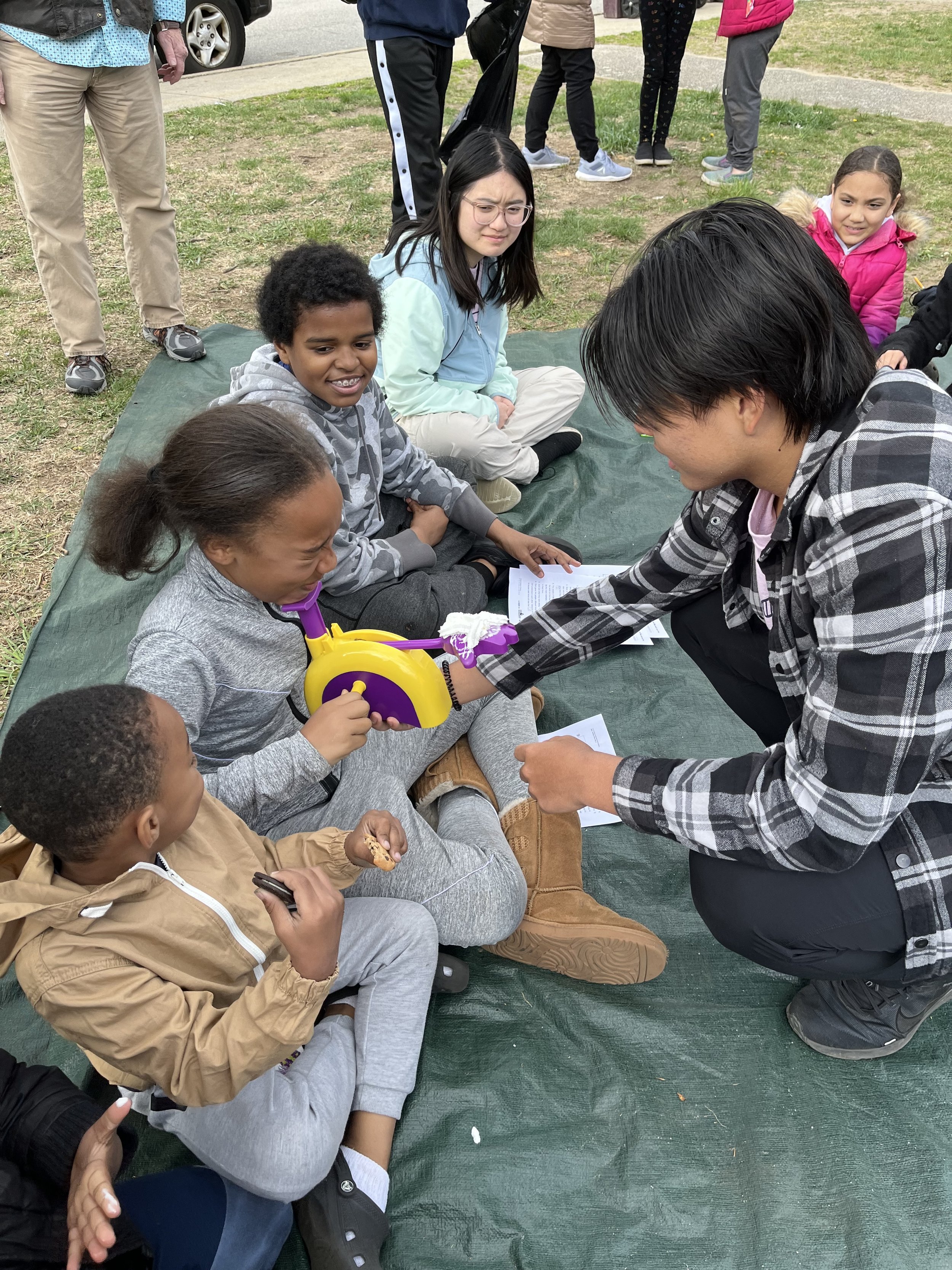 Day 3 - Mission team members playing PieFace game with  neighbourhood children at Kids Camp