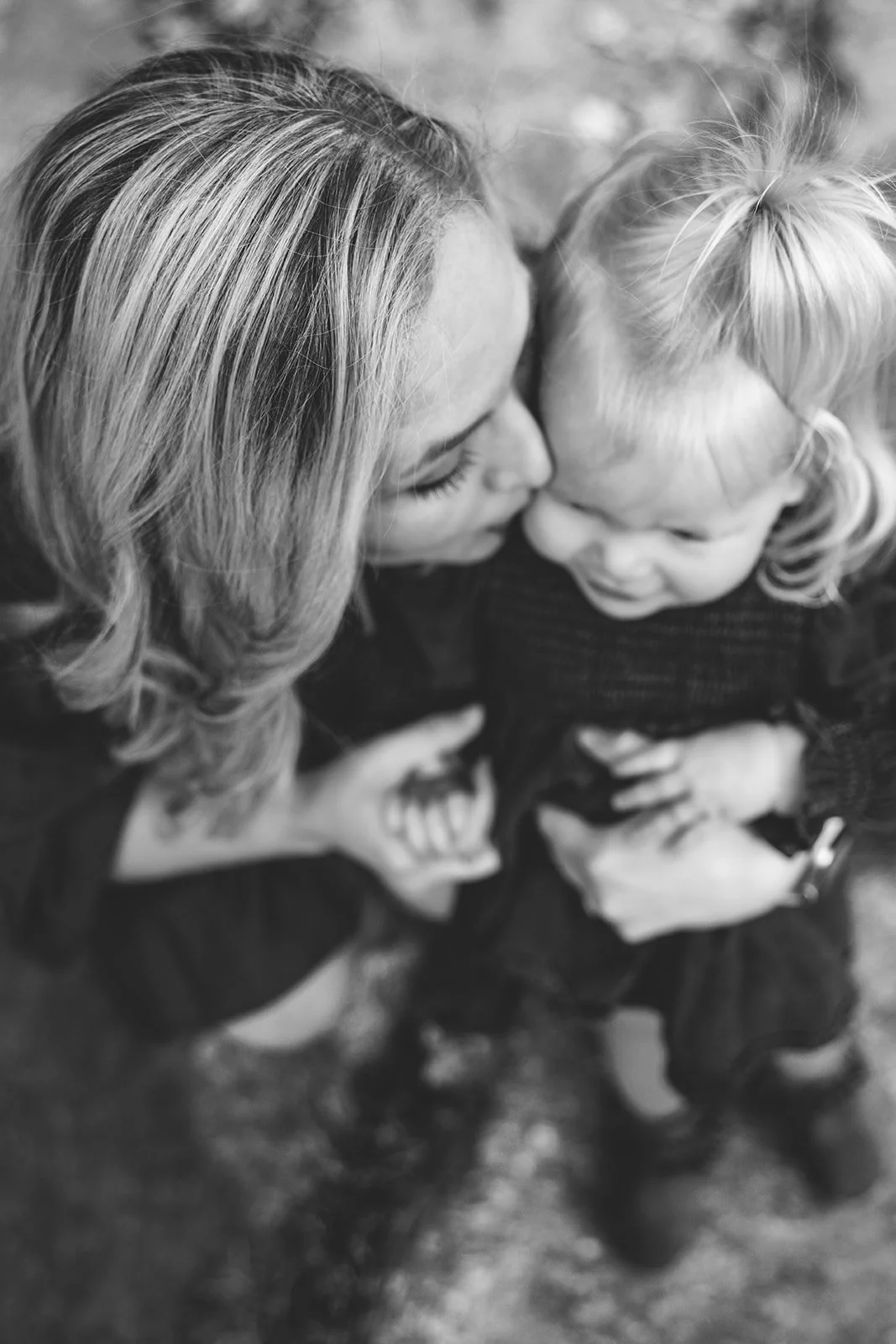 Authentic motherhood photography in Denver capturing mom hugging toddler with love and connection.