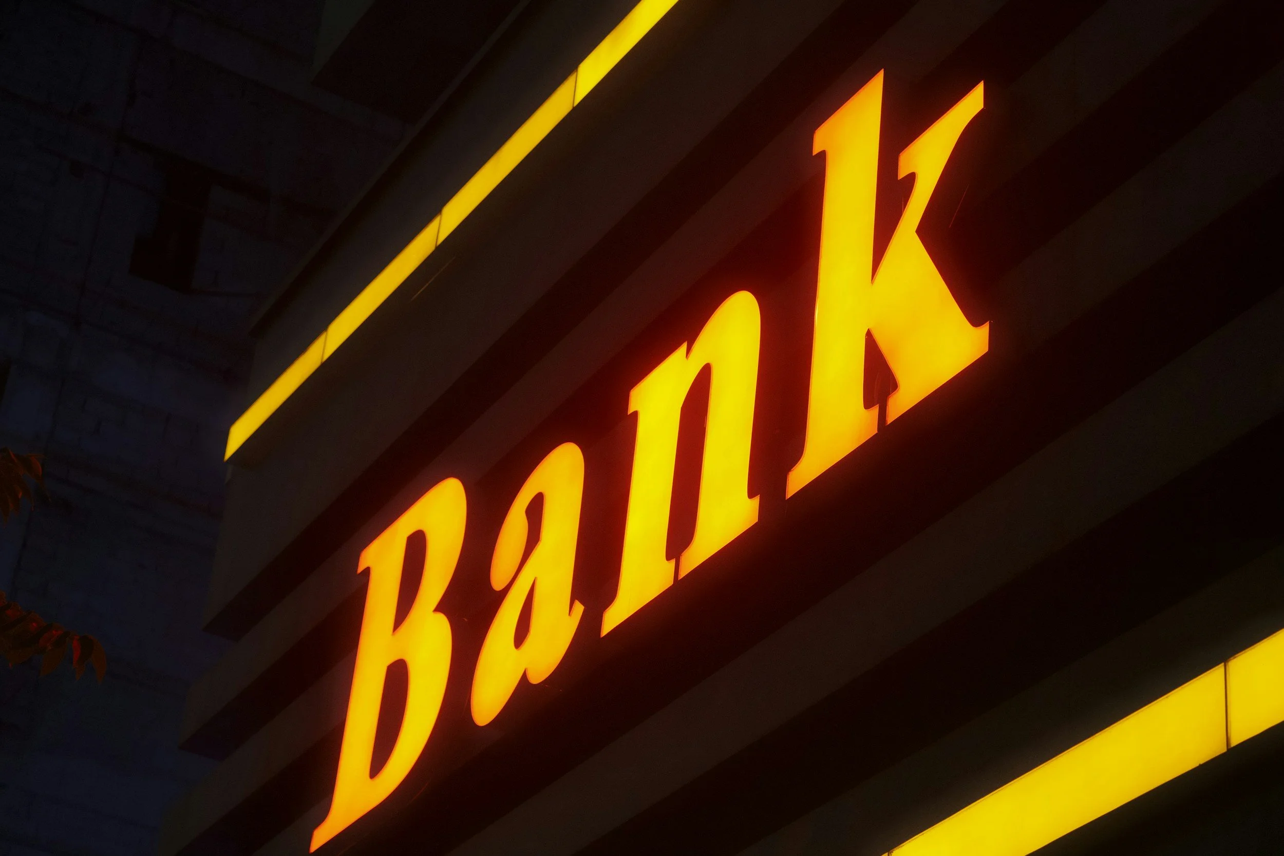 Bright yellow neon sign reading 'PARK LOT' against a dark background.