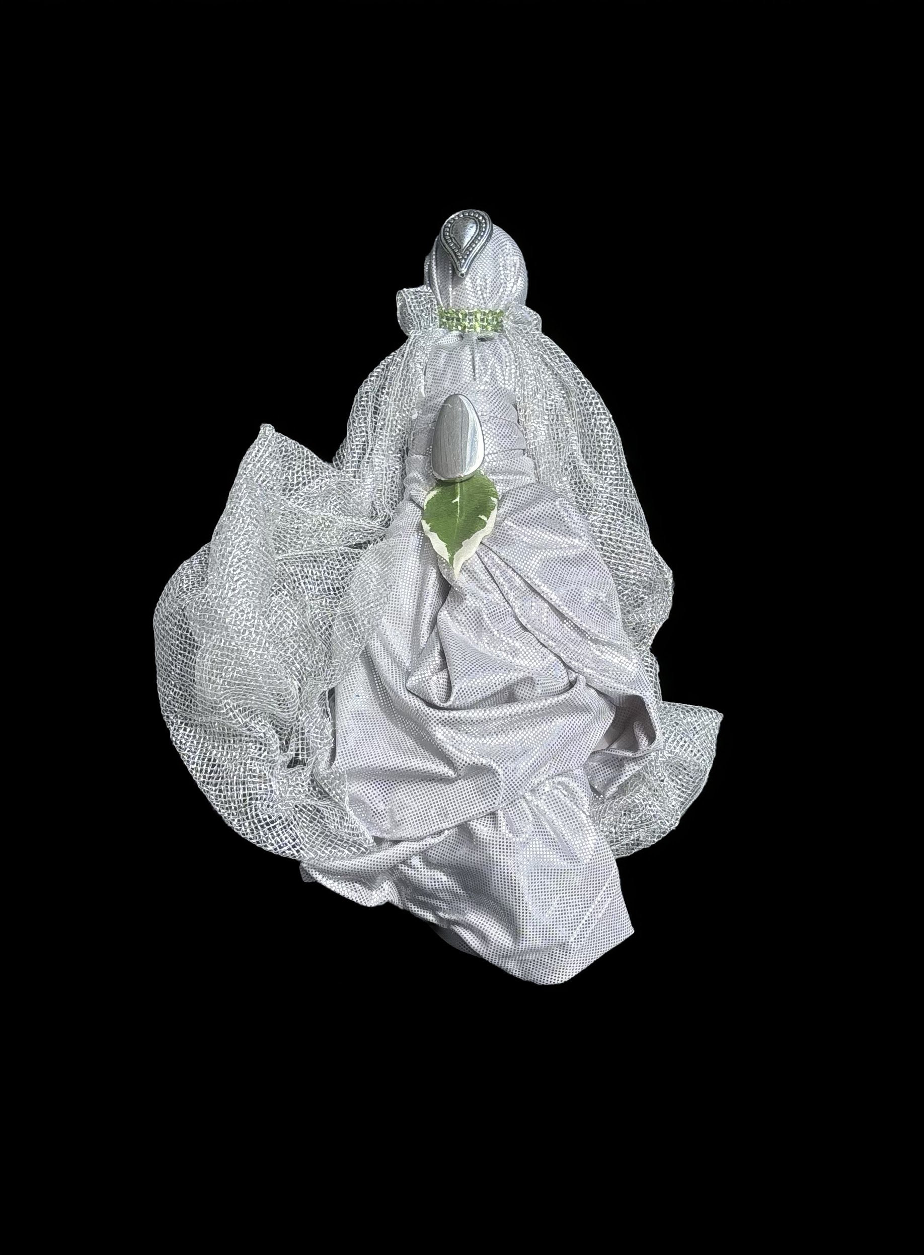  Ascension Spirit   
Soft Sculpture 
 Found Materials   
Discarded Doll, Fabric,  
Found Natural Materials,  
Costume Jewelry, Plastic Gems