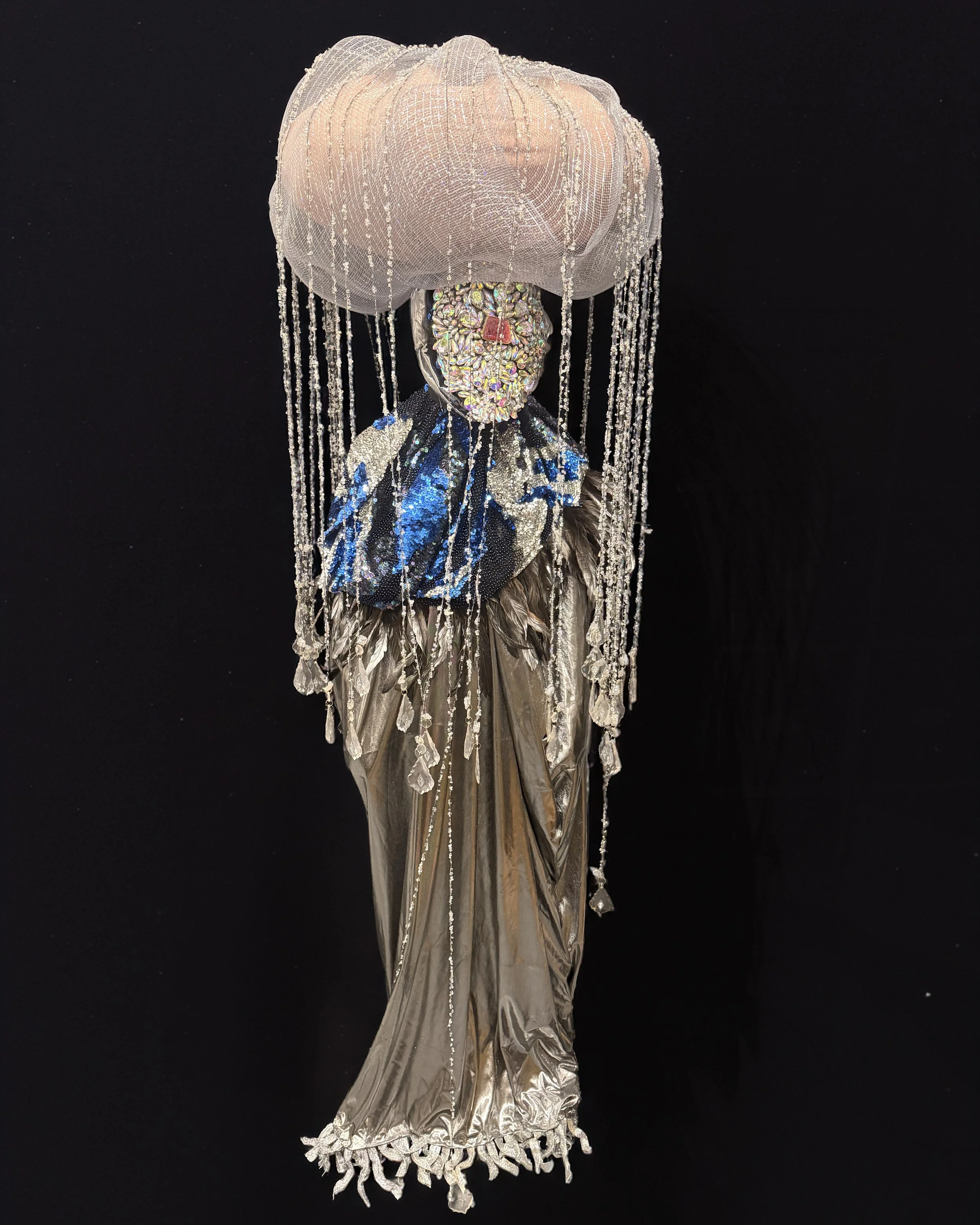  Ascension Spirit   
Soft Sculpture 
 Found Materials   
Discarded Doll, Fabric,  
Found Natural Materials,  
Costume Jewelry, Plastic Gems