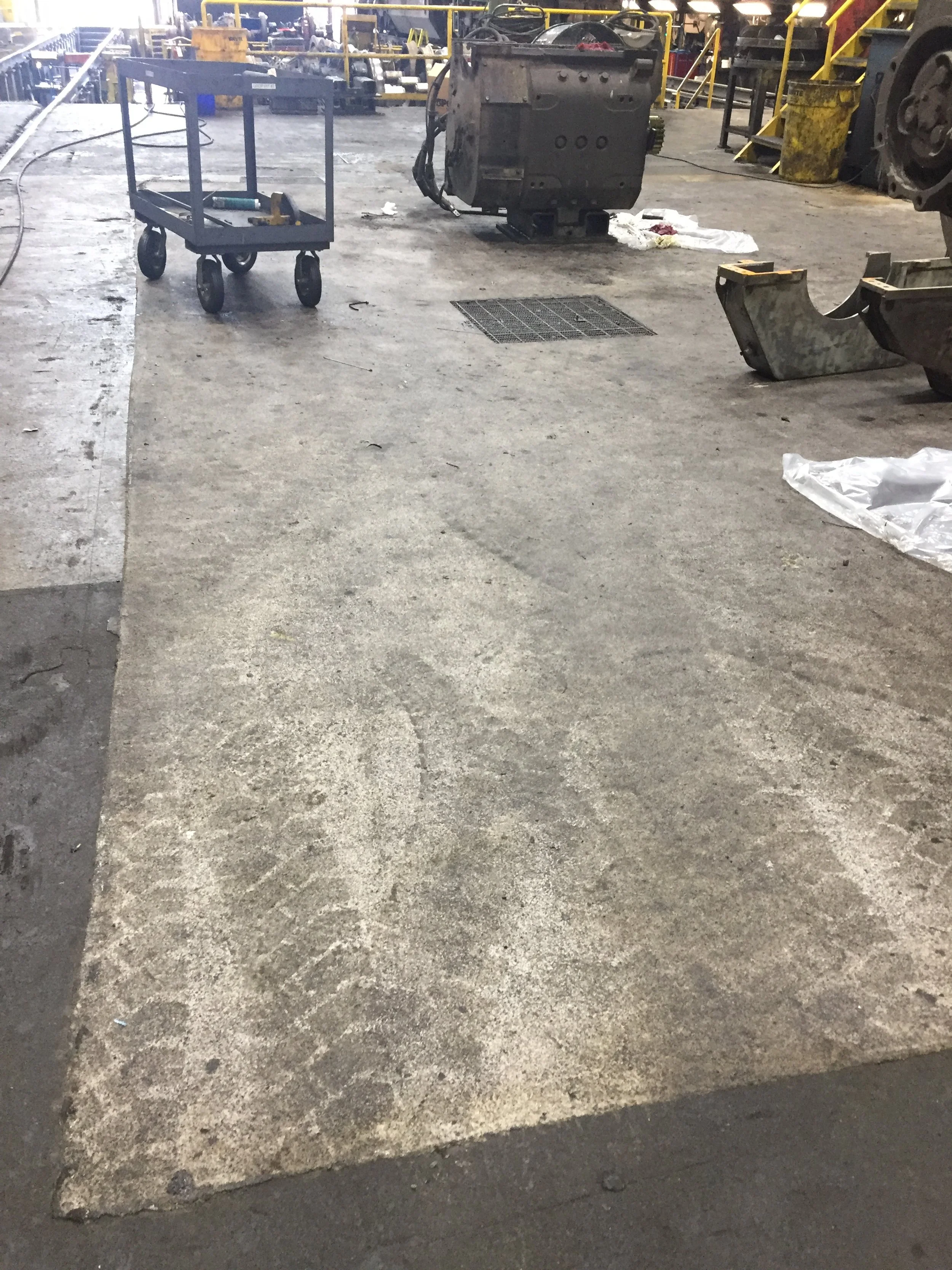 Quickly, the wheeled traffic gets the 
 floor dirty.  That's life.  Cleaning more frequently would result in a easier to clean surface.  But, the client is happy with the anti slip, drainage performance of the floor and the drainage provide.