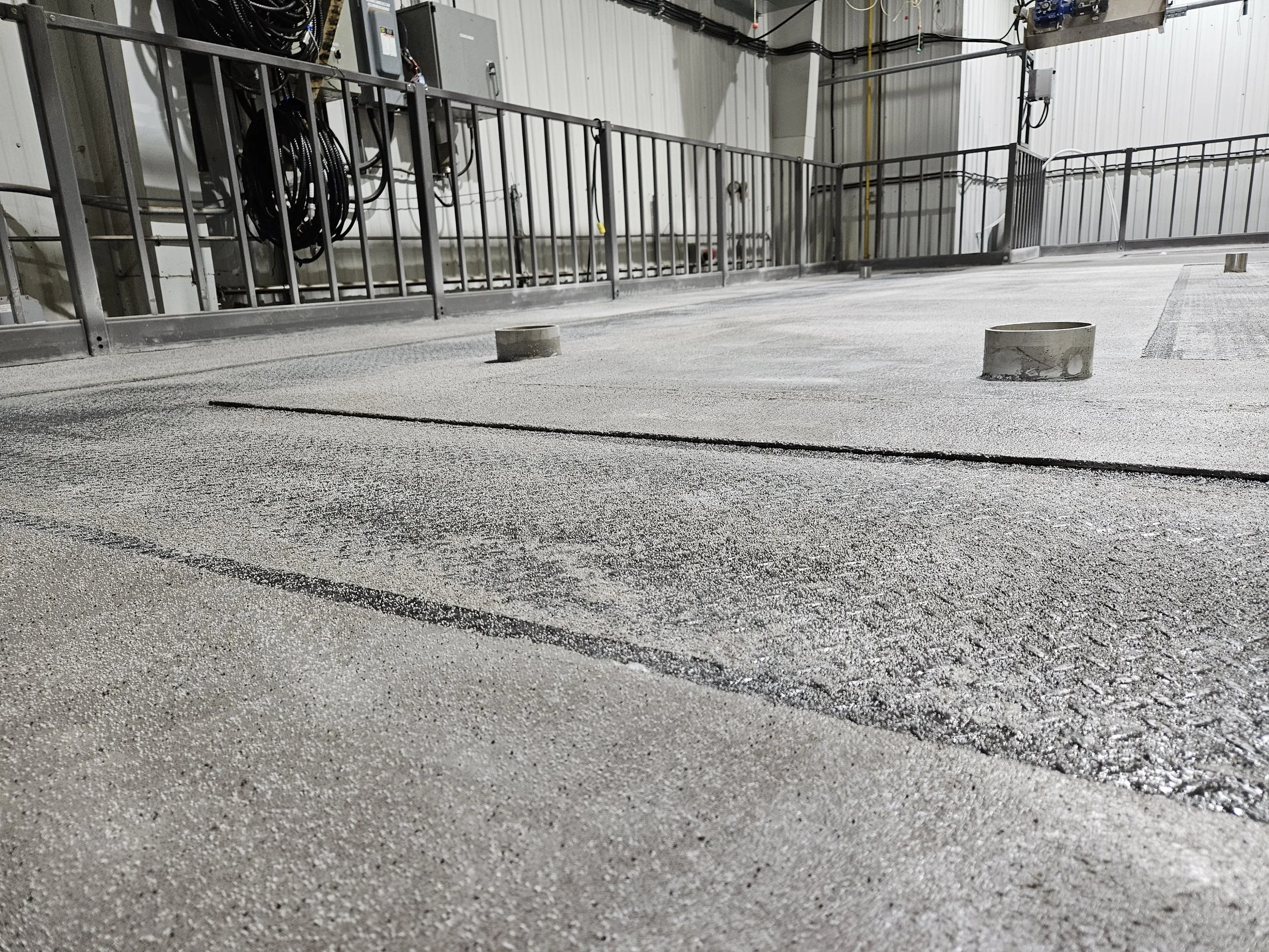 The Silikal R17 plastic concrete cures to 80 to 90 MPa in less than 2 hours. We could not use cementitious concrete is it would not bond properly in a thin layer, and it would have poor compressive strength.