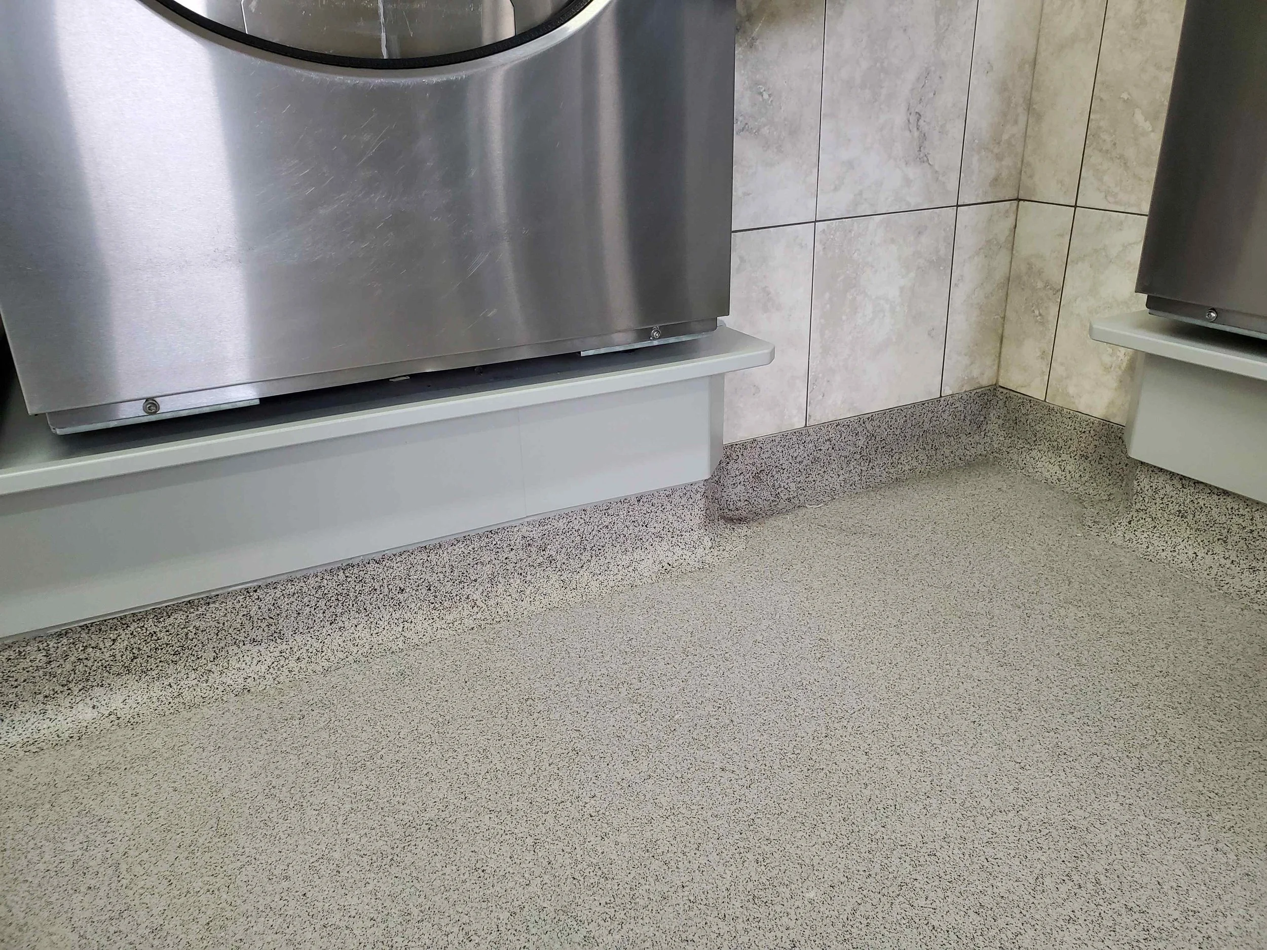The same area of floor and cove picture taken 6 years later in 2021. Perfect condition! Sharp corners eliminated with our radial cove makes keeping this room clean a breeze.