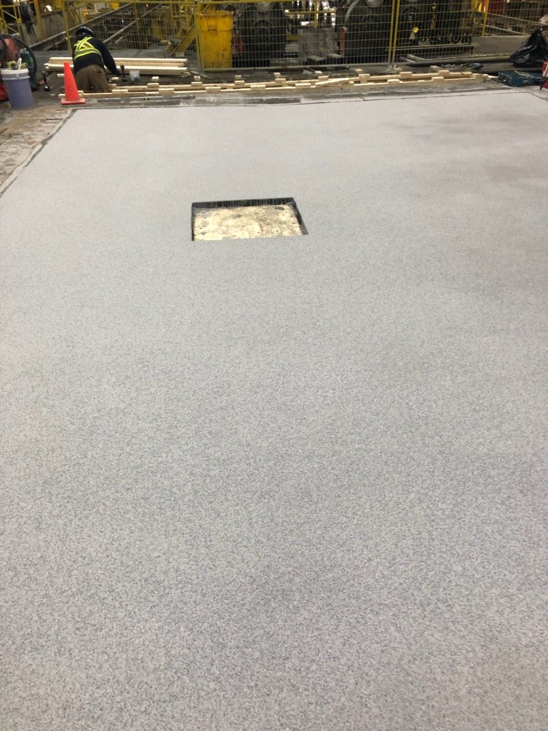 SureBond Complete.  11 days on-site.  If this project had involved concrete replacement with a typical epoxy floor, this would have been 5-6 weeks duration with the same result.  After all slab repair work was complete, we sloped the floor and instal