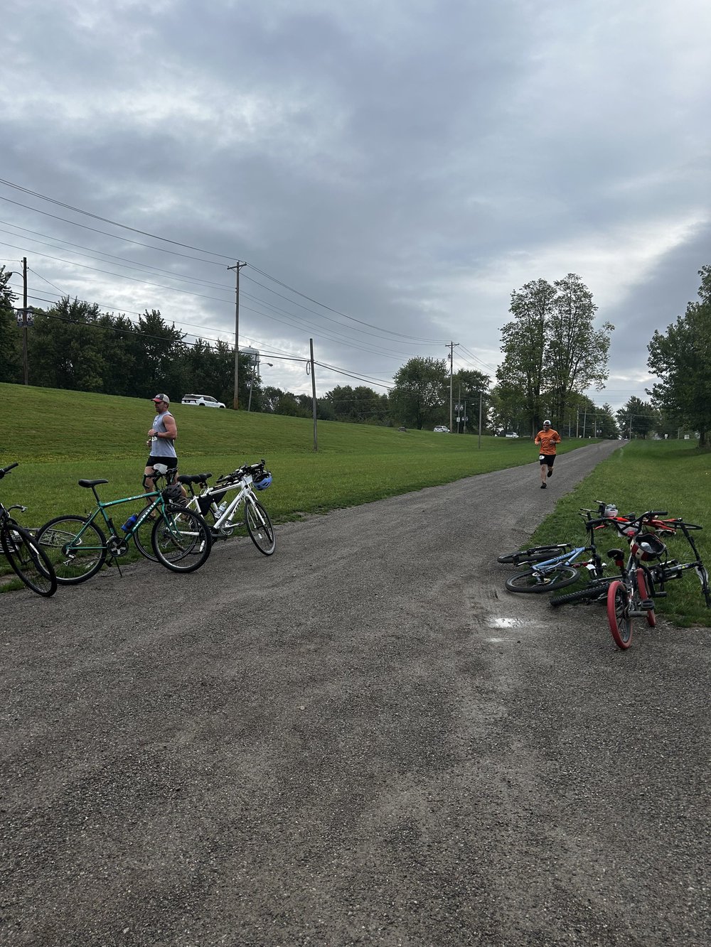 Racers run to their bikes after the trail run
