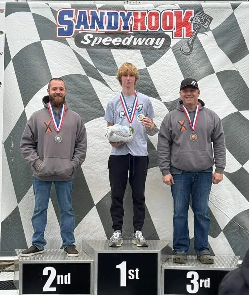 LO206 go kart driver accepting his first place win on the podium.
