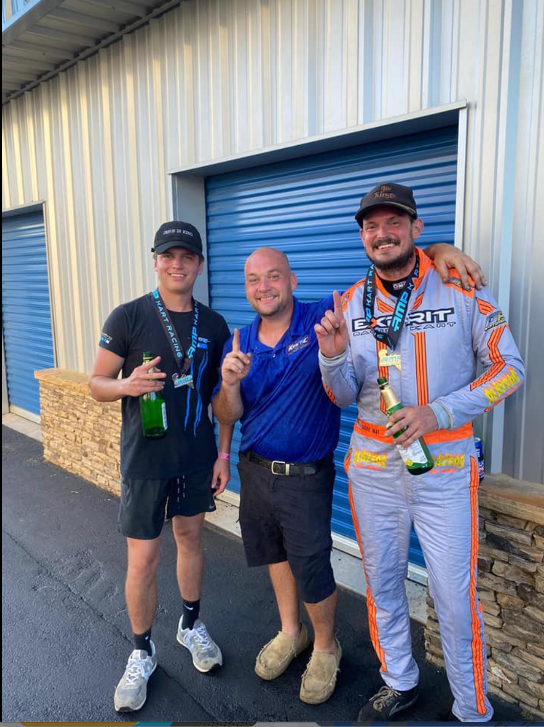 three LO206 go kart winners posing with their trophies.