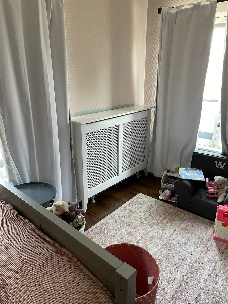 Custom white radiator cover in place beneath the window.