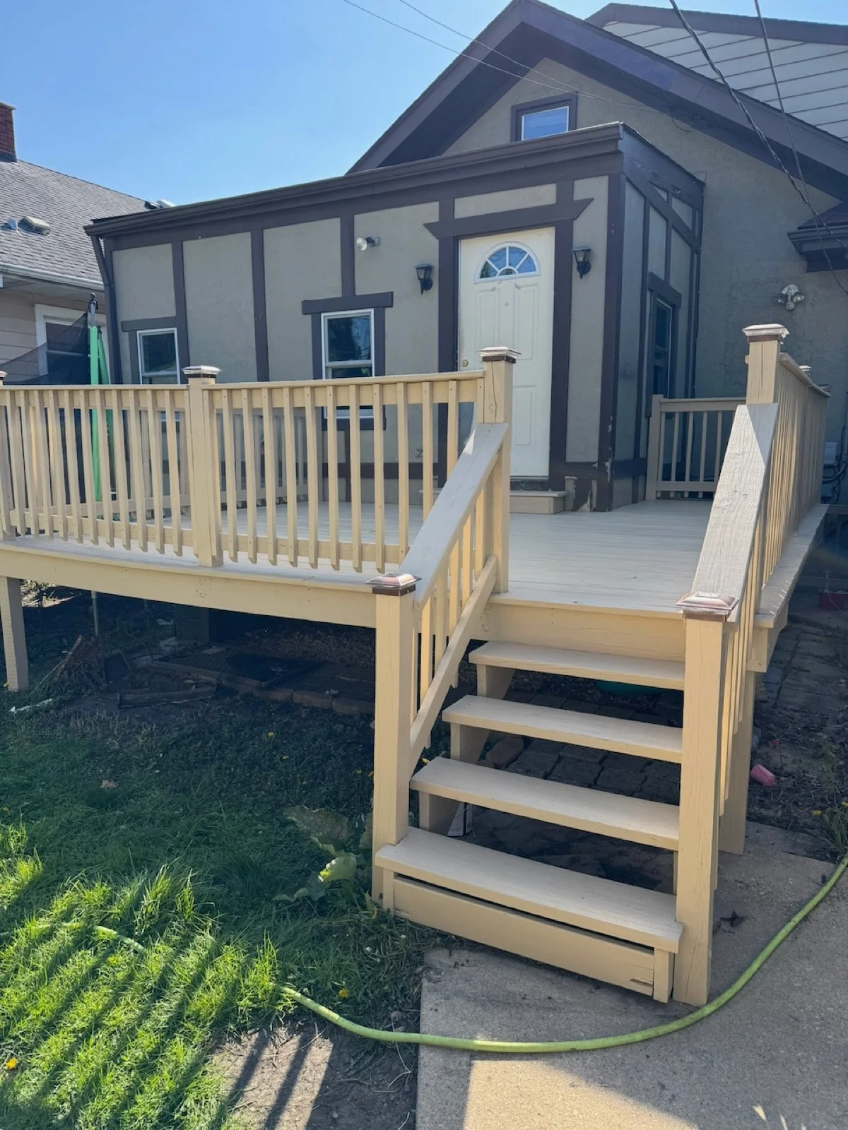 02-finished-rear-deck-with-wood-stairs-and-railings.jpg