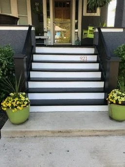After — black trim, white risers, and finished entry stairs — Black & White Front Entry Stairs