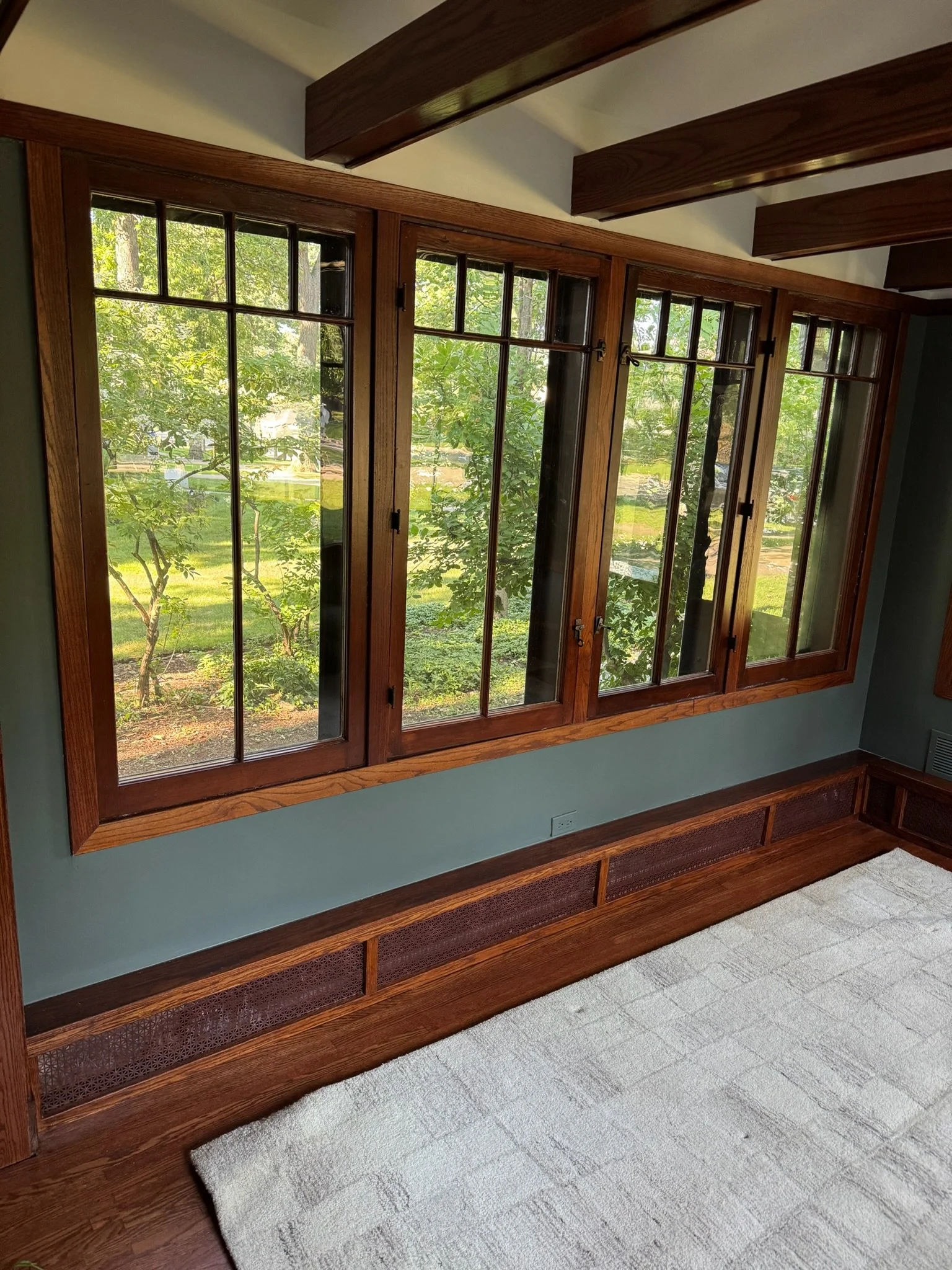 After repair: painted wall beneath the wood-framed windows.