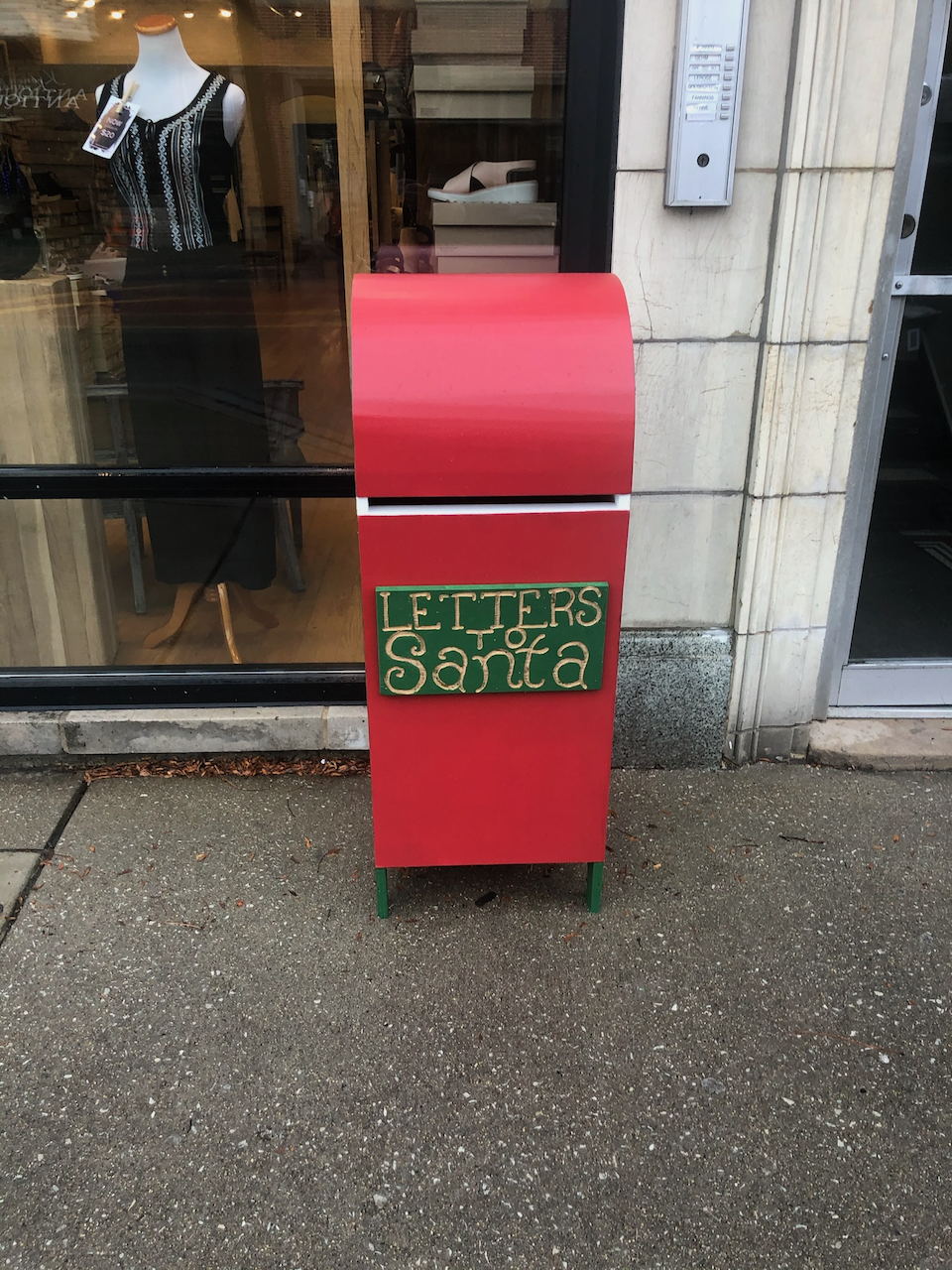 Installed curved-top Santa mailbox outside the storefront.