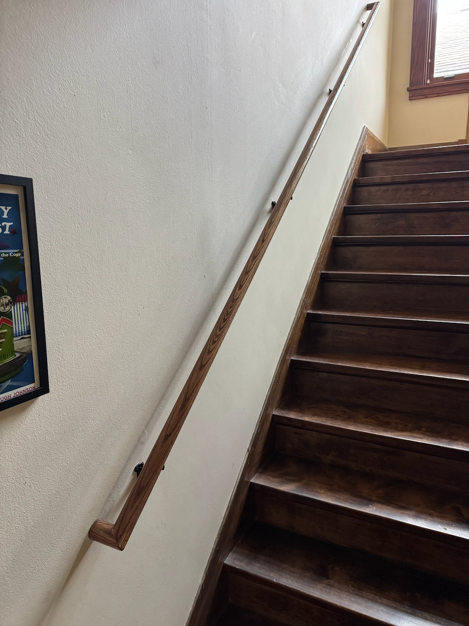 Before: existing wood staircase before tread restoration.