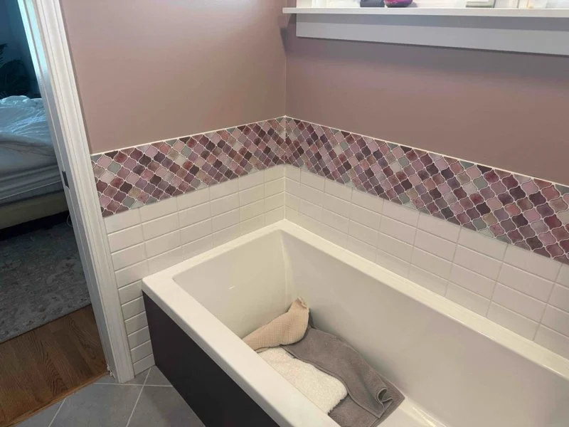 Bathroom before tile replacement, with the original mosaic accent band