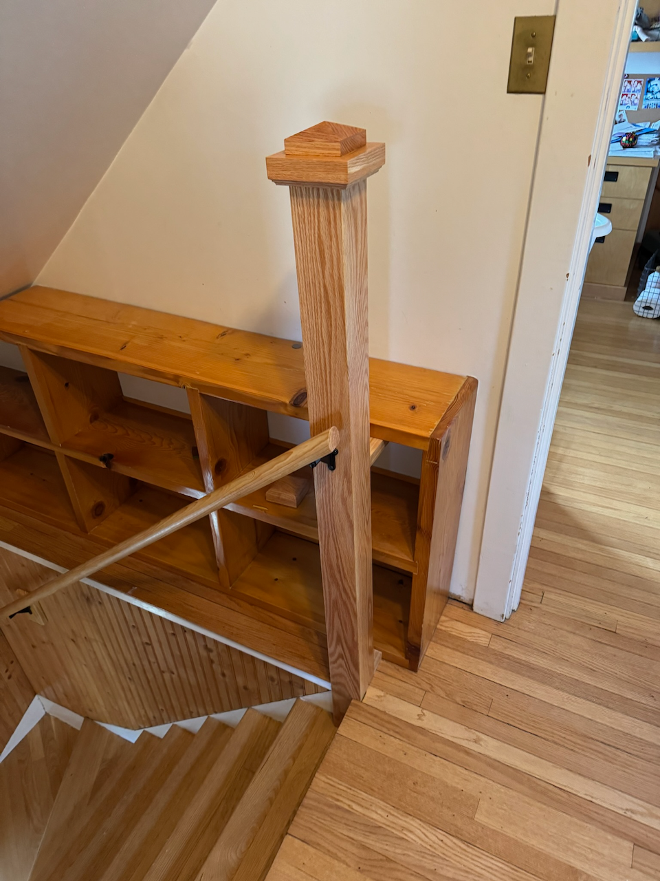 During: wood newel post and stair landing railing work in progress.