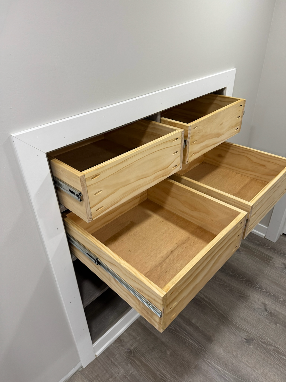 Open wood trays showing the pull-out storage mechanism.