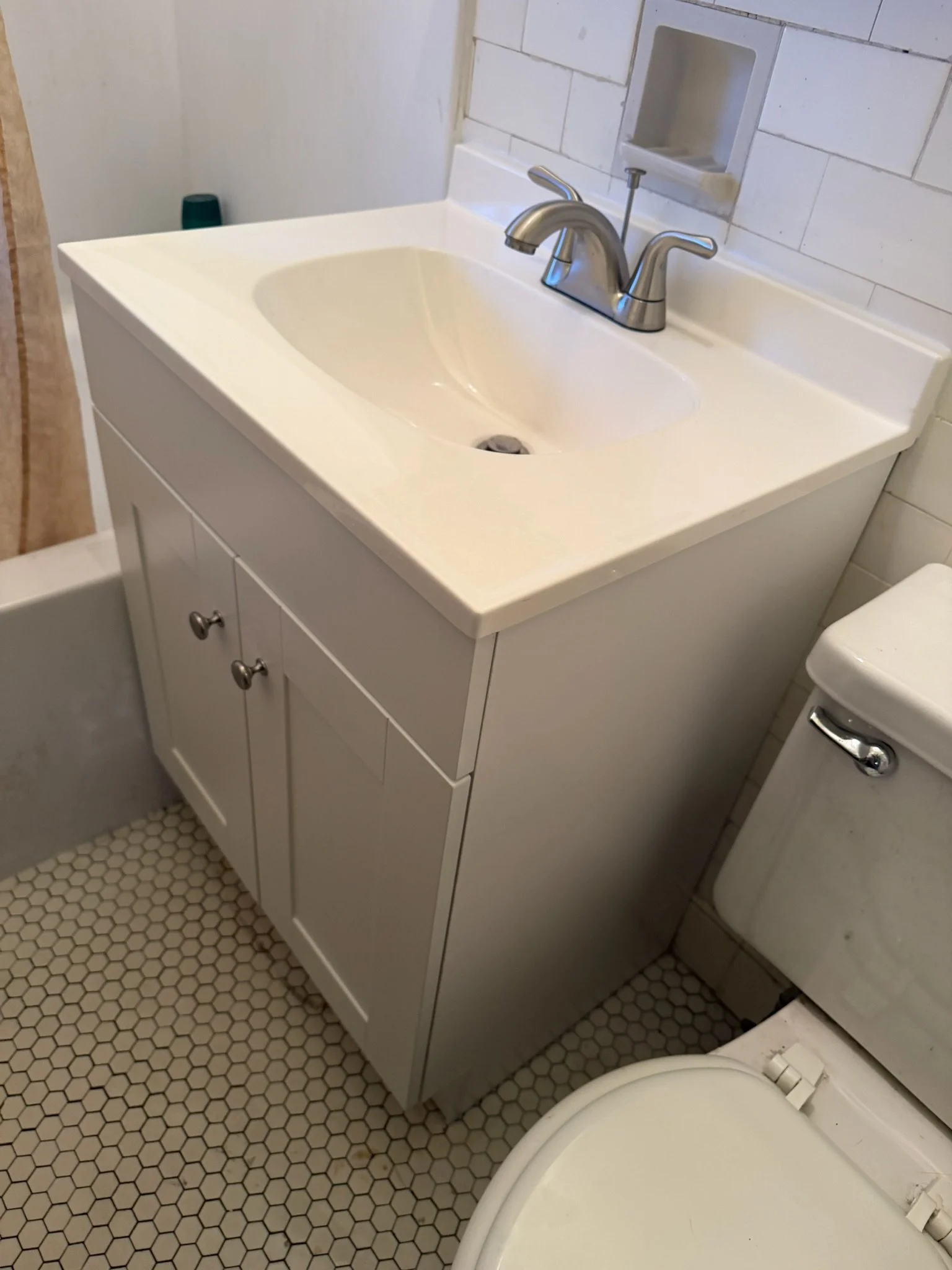 Bathroom vanity with an integrated sink and brushed-nickel faucet.