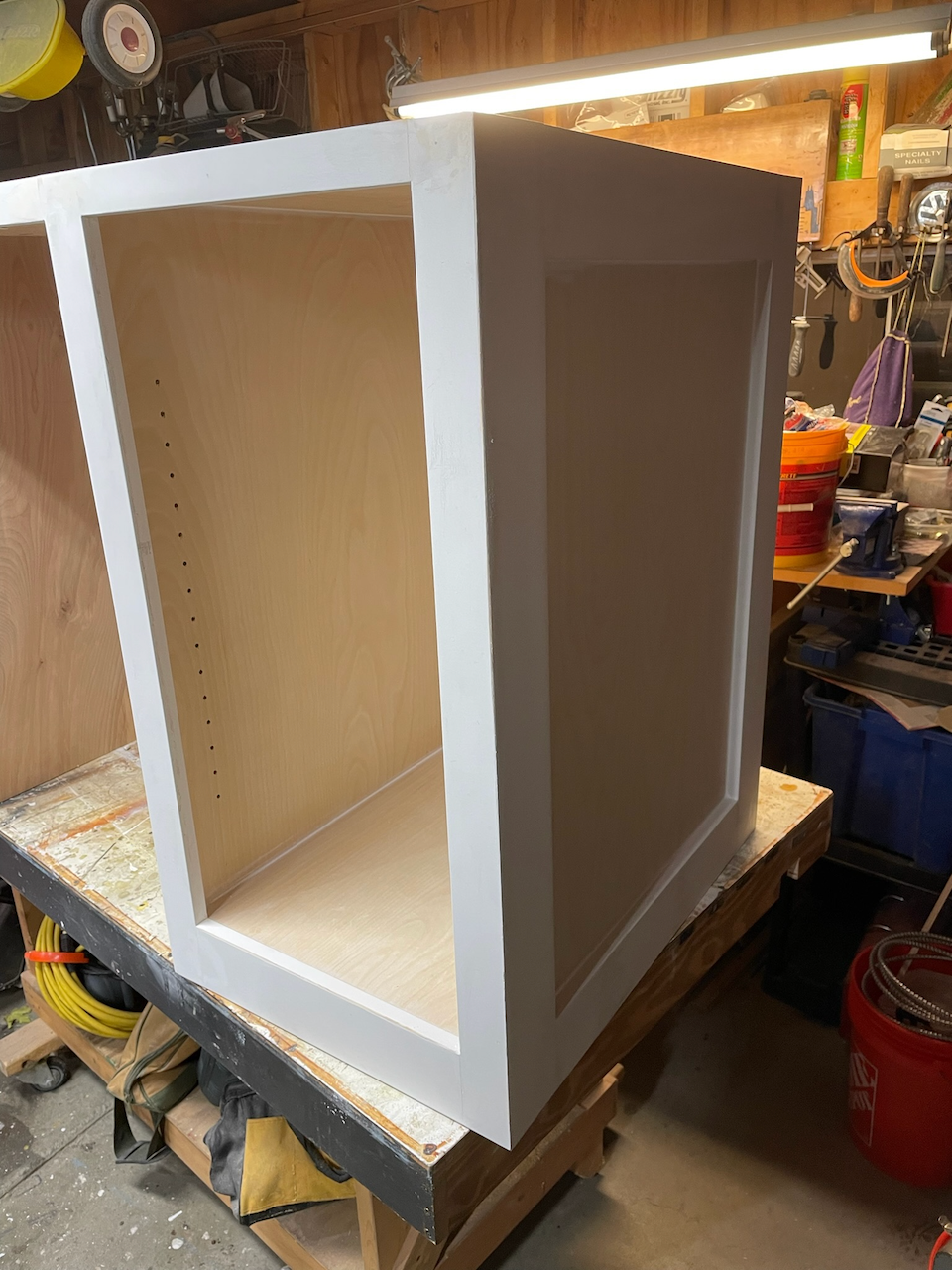 Painted wine bar cabinet with shelf compartments before final installation.