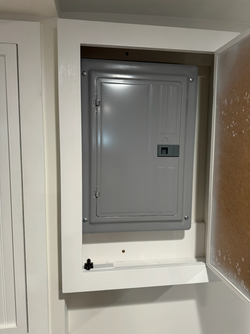 Utility access cabinet open to reveal the existing panel.