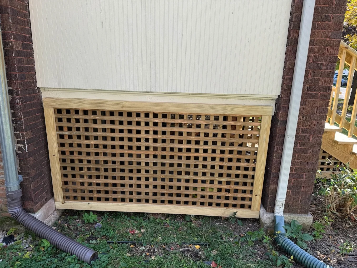 Replacement wood lattice panel beneath the enclosed porch.