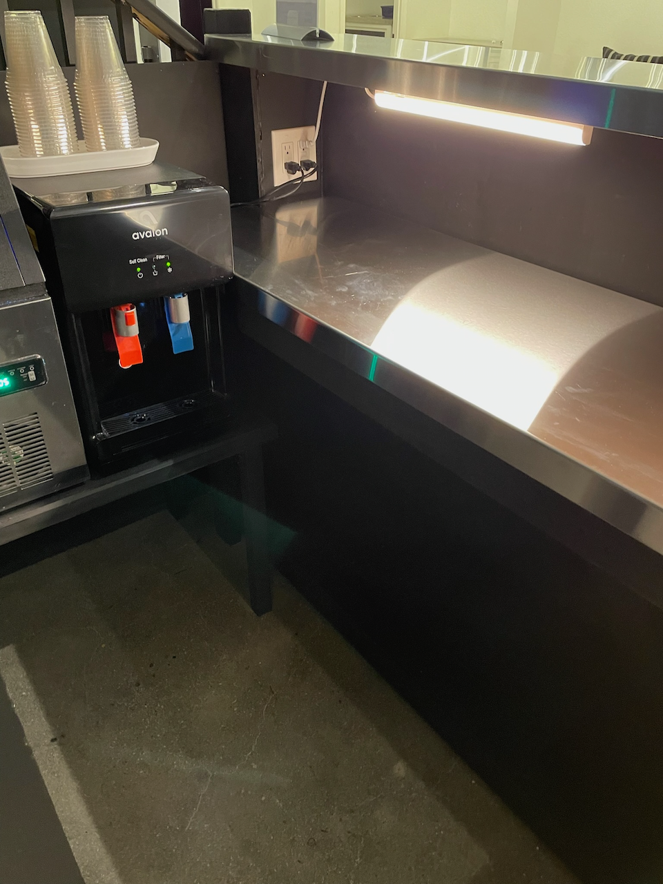 Inside view of the illuminated bar counter and serving area.