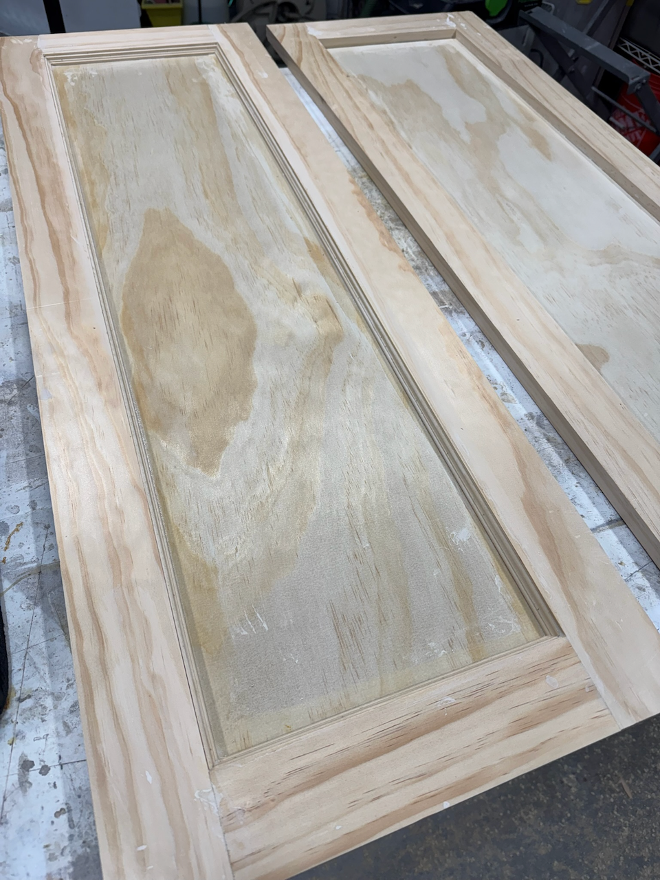 Before: worn finish on the paneled cabinet door.