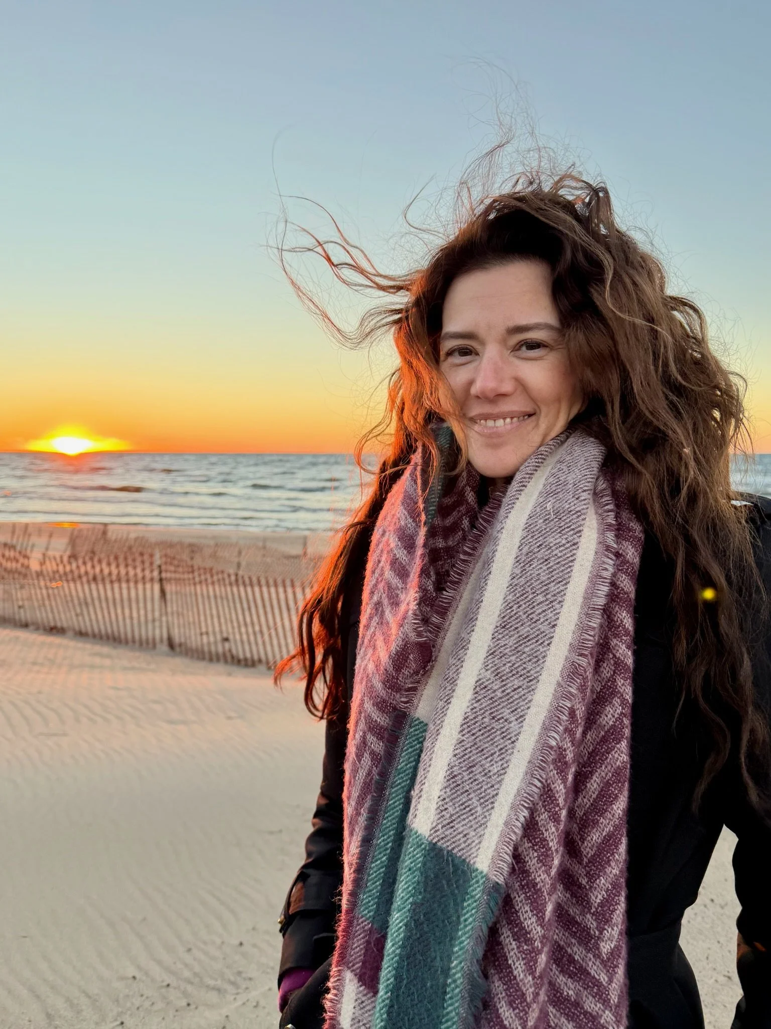 Sarah Gullette, founder of The Oak Park Handy Human, at the beach at sunset