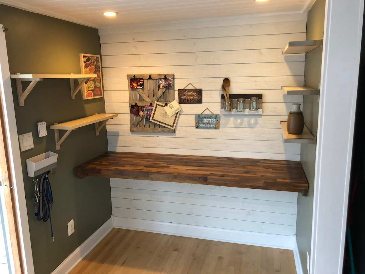 Angled view of the built-in writing desk and open shelving.