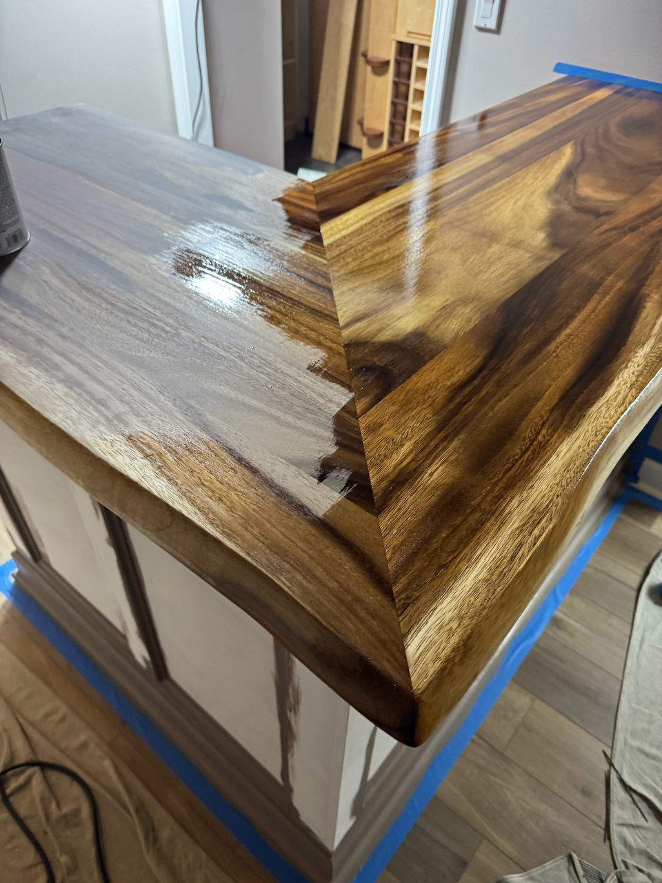 During: fitting the live-edge wood countertop around the bar corner.