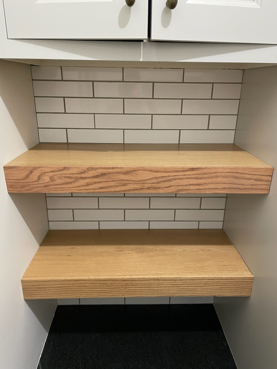 Close view of the wood grain and floating shelf edges.