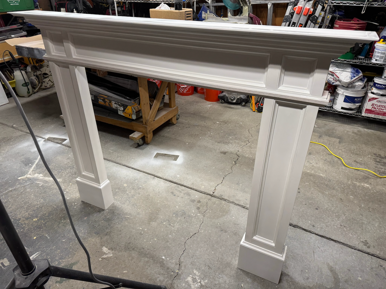 Painted fireplace mantel and surround during workshop assembly.