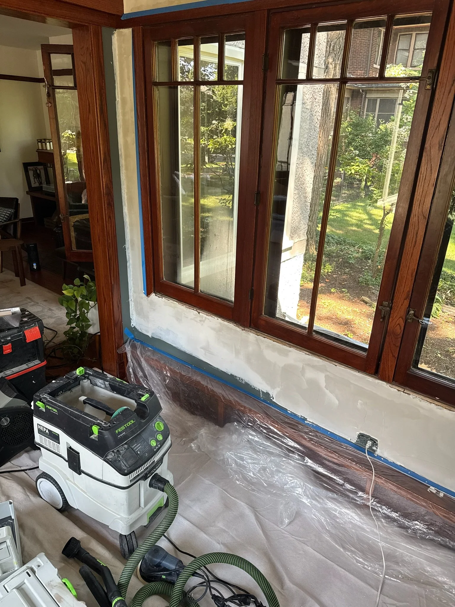 Another view of plaster repairs around the wood-framed windows.