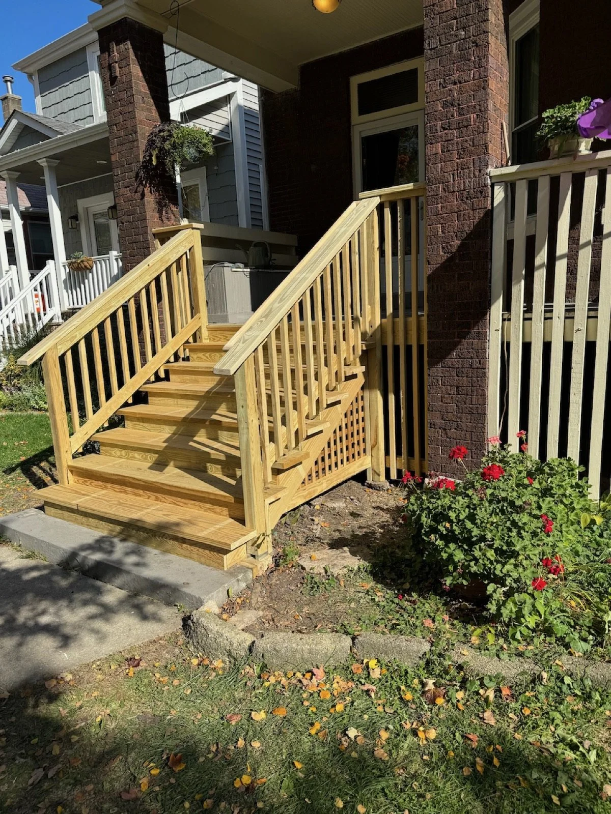 Rebuilt front porch stairs with new wood handrails and balusters.