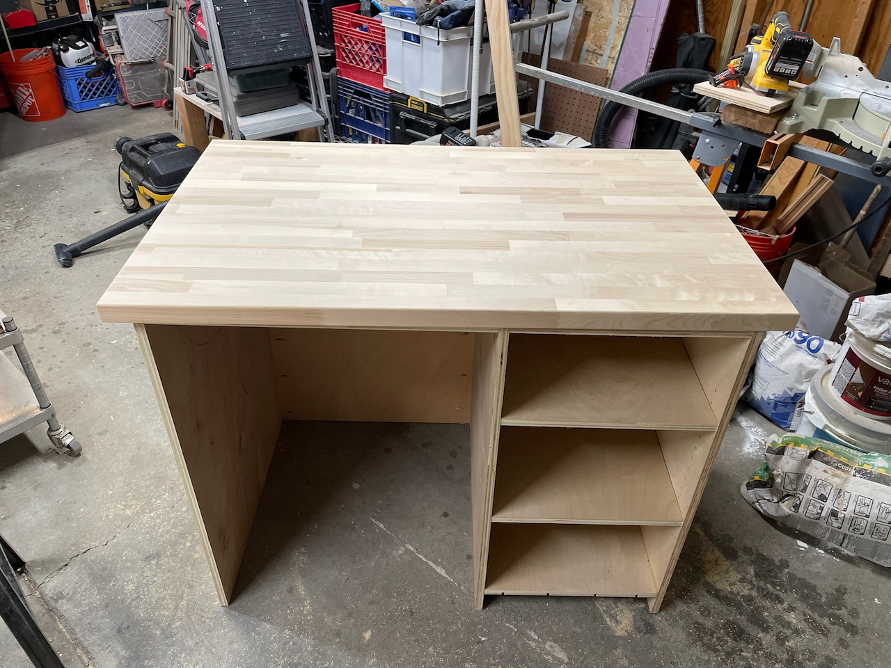 Wine bar cabinet and butcher-block countertop during workshop construction.