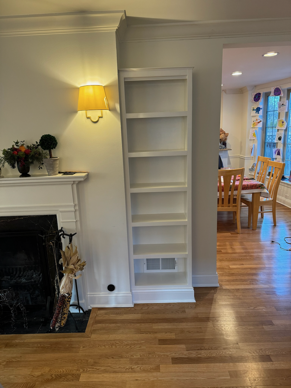 Installed bookcase on one side of the fireplace.