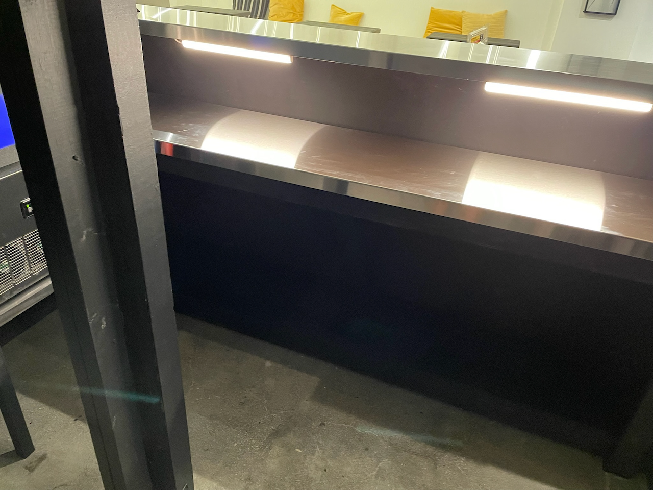 Detail of the illuminated work surface behind the bar.