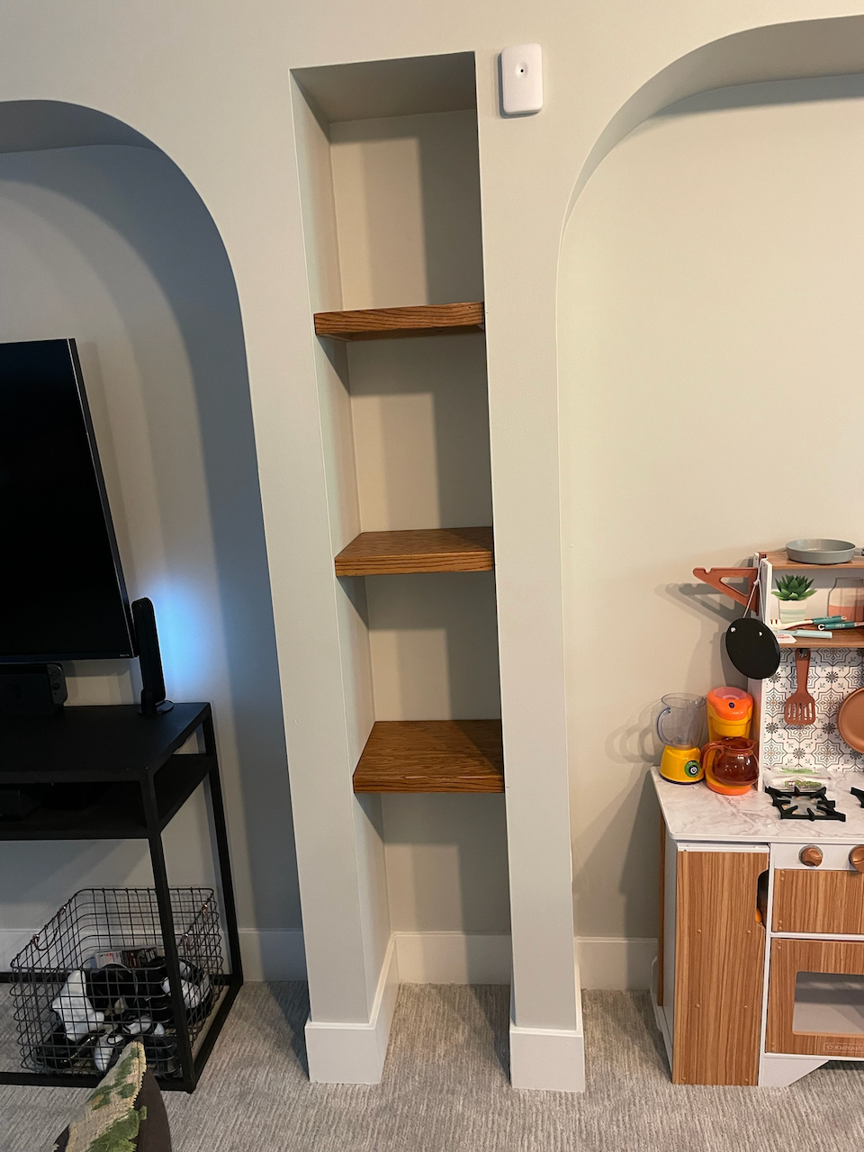 Wood Shelves Between Arched Doorways