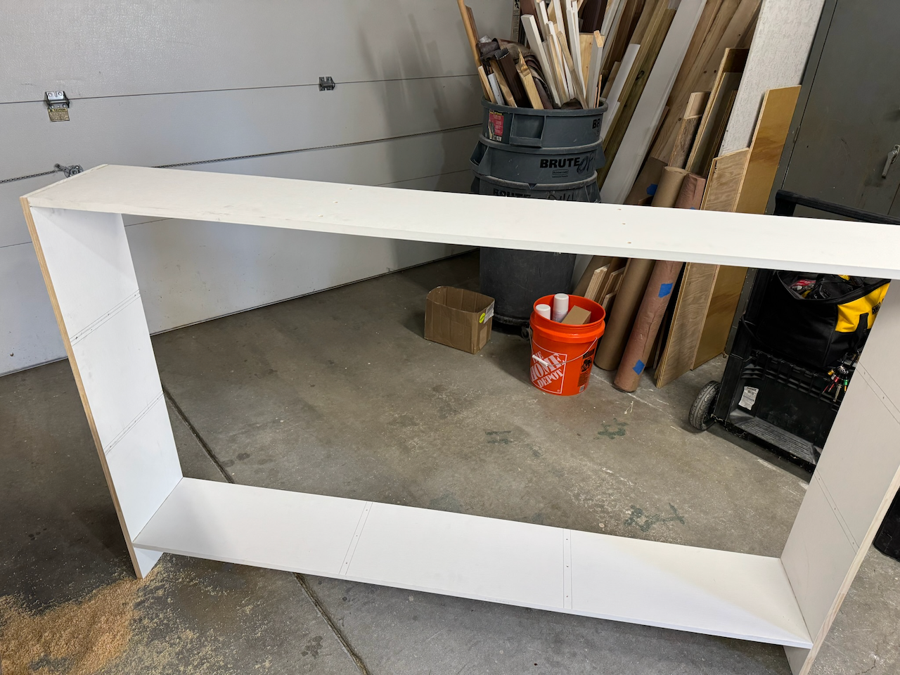 White bookcase frame during workshop assembly.
