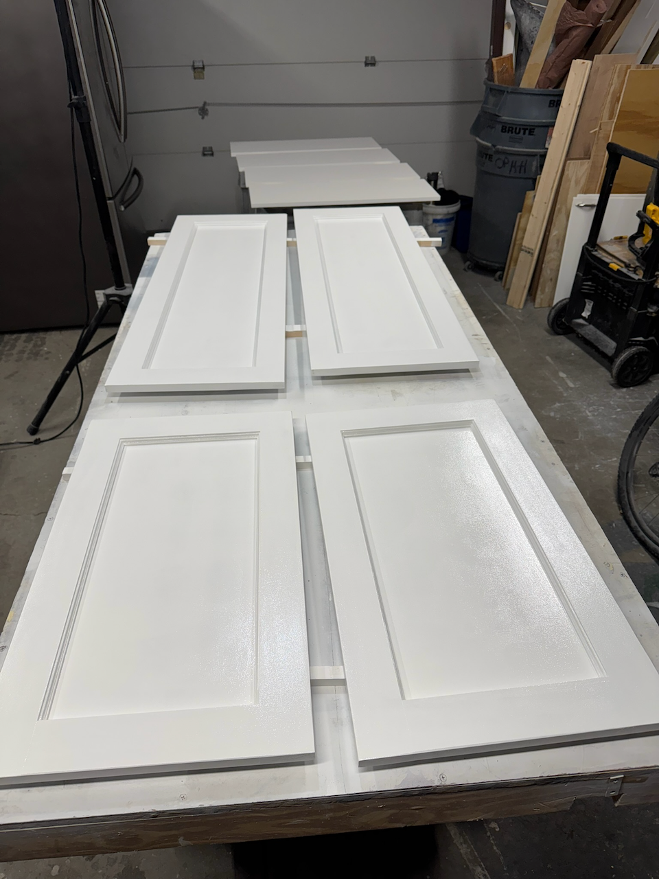 During: cabinet doors primed and painted in the workshop.