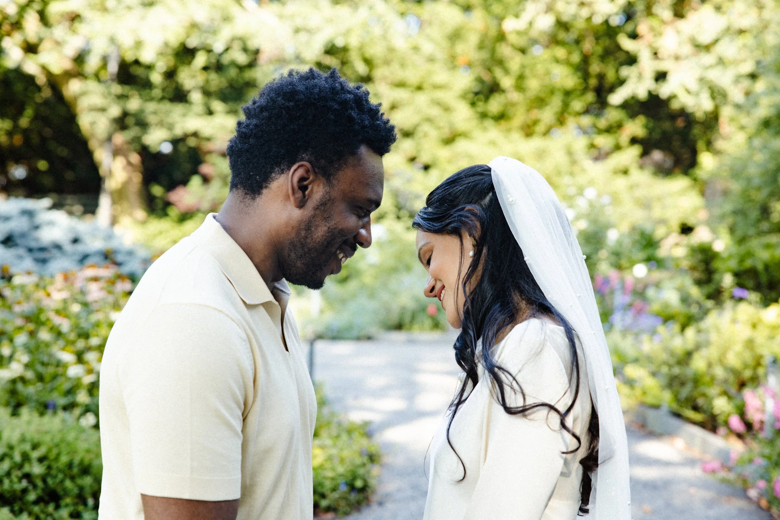 Couple smiling at each other during elopement photoshoot at Fort tryon park