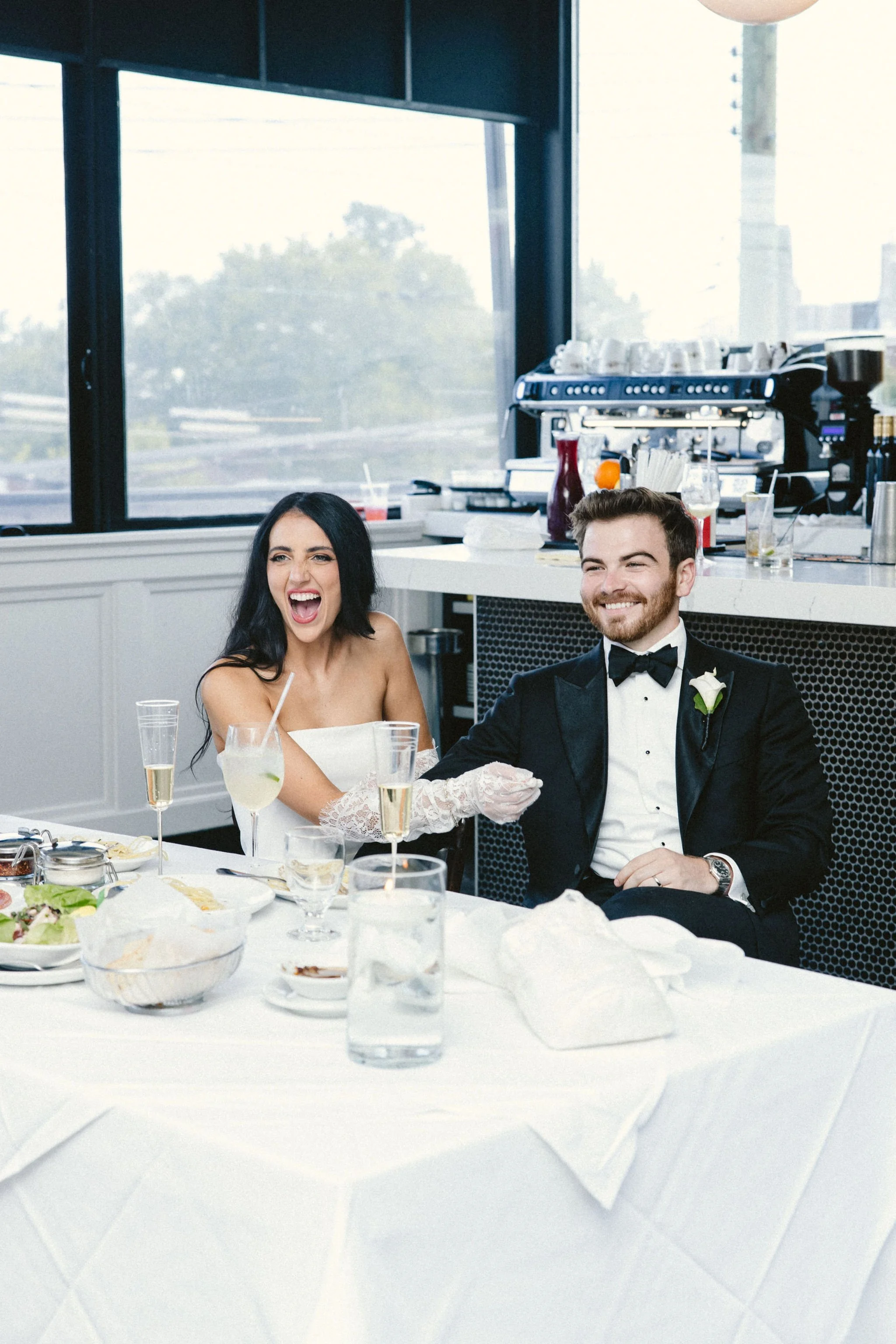 bride and groom laughing during wedding reception